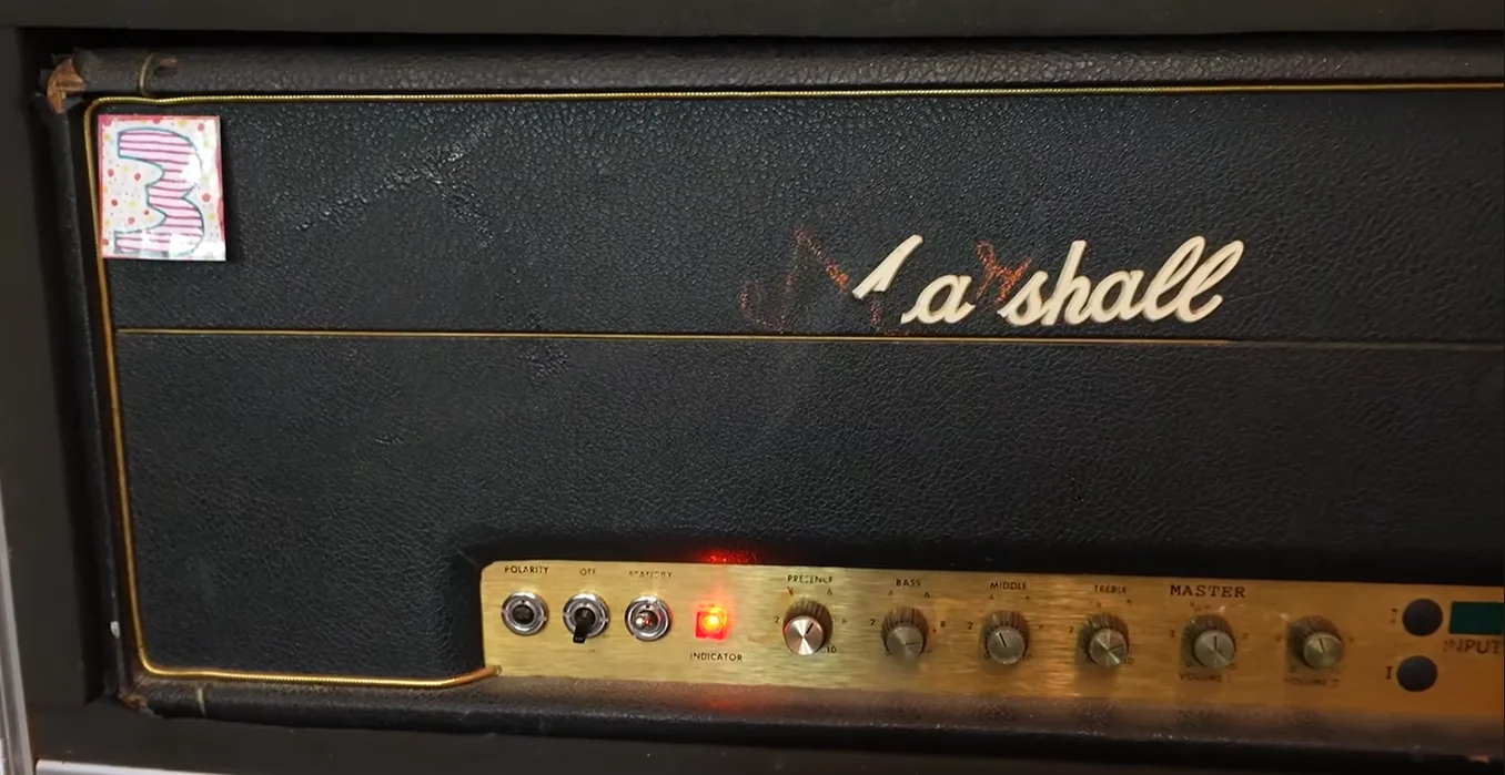The original custom Marshall 1959SLP with the inputs capped and MASTER above Volume 1. The logo filled in with Crayon