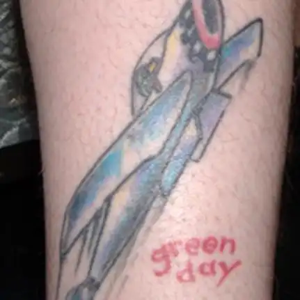 Jet with Green Day Logo Tattoo