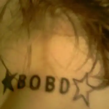 Text and Star Tattoo