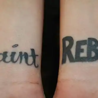 Saint and Rebel Text Tattoo