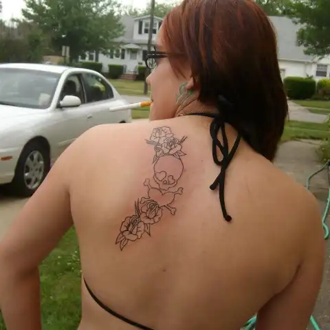 Skull and Crossbones with Flowers Tattoo