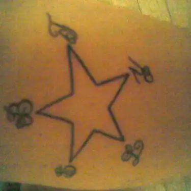 Outlined Star with Small Floral Details Tattoo