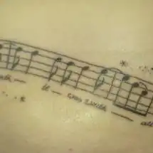 Musical Staff with Skulls and Stars Tattoo