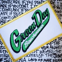 White, gold and green logo patch