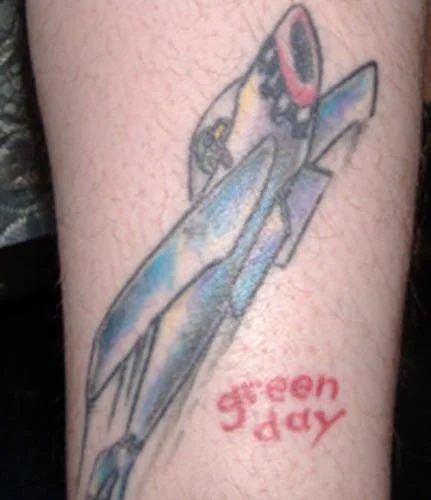 Jet with Green Day Logo Tattoo
