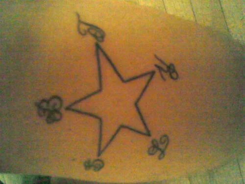 Outlined Star with Small Floral Details Tattoo