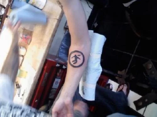 Warning Man Logo Tattoo