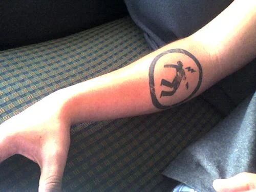 Warning Man Logo Tattoo