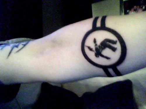 Warning Man Logo Tattoo