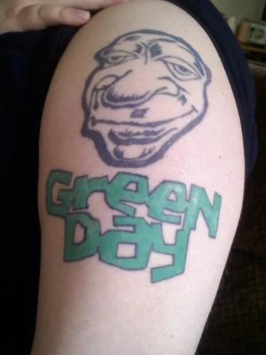 Green Day Logo with Cartoon Face Tattoo