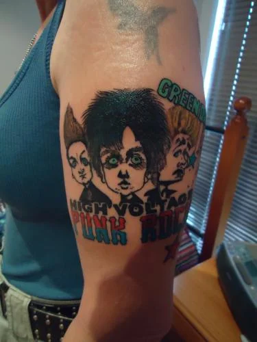 Green Day Logo with Three Cartoon Faces Tattoo