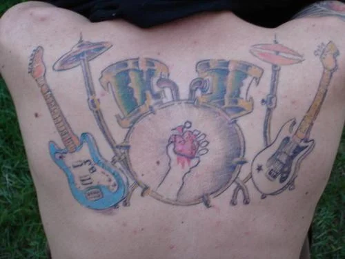 Drum Kit with Hand-Held Heart and Guitars Tattoo
