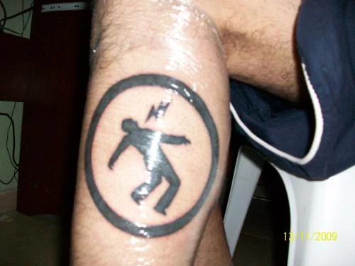 Warning Man Logo Tattoo