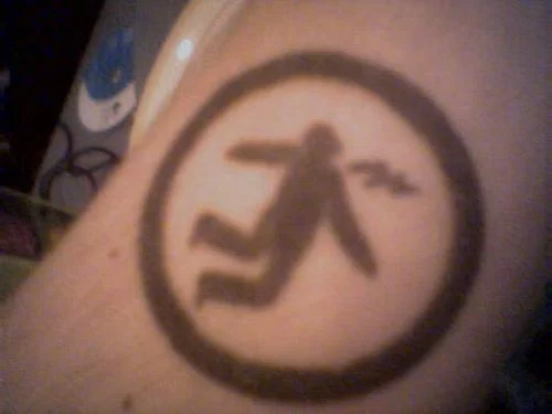 Warning Man Logo Tattoo