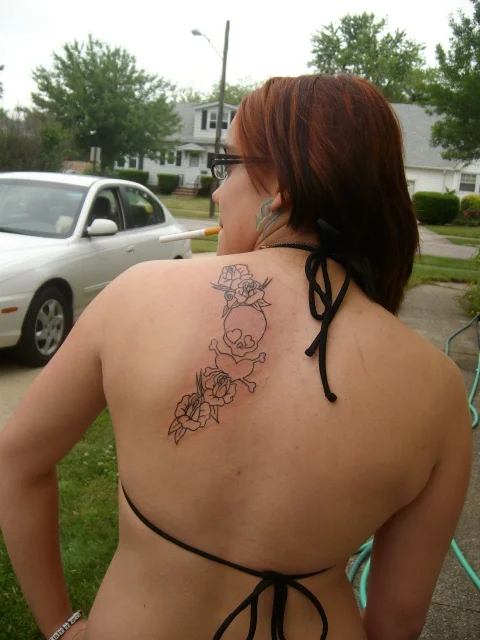 Skull and Crossbones with Flowers Tattoo