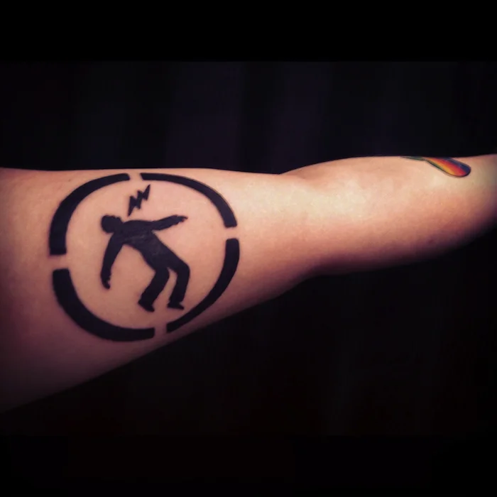 Warning Man Logo Tattoo
